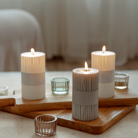 Home still life with burning candles as home decor details.